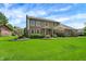 Charming two-story brick home with a well-manicured lawn, lovely landscaping, and a welcoming front entrance at 195 Lake Dr, Greenwood, IN 46142