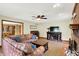 Bright living room featuring a brick fireplace, ceiling fan, and a comfortable sectional sofa at 195 Lake Dr, Greenwood, IN 46142