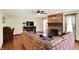 Spacious living room with brick fireplace, media center, ceiling fan and comfortable sectional sofa at 195 Lake Dr, Greenwood, IN 46142