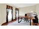 Bright office with hardwood floors, a large desk, and natural light from a window dressed with dark curtains at 195 Lake Dr, Greenwood, IN 46142