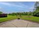 Large backyard featuring a concrete patio and views of a lush field at 2557 Cedarcrest Dr, Columbus, IN 47203