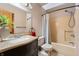 Well-lit bathroom features a shower-tub combo, granite countertop, and modern sink at 2557 Cedarcrest Dr, Columbus, IN 47203