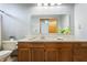 Bathroom vanity with ample cabinet space, countertop, and large mirror at 2557 Cedarcrest Dr, Columbus, IN 47203