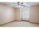 Bedroom showcasing a large window, ceiling fan, and neutral carpeting at 2557 Cedarcrest Dr, Columbus, IN 47203