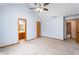 Spacious bedroom featuring a ceiling fan and adjoining bathroom for added convenience at 2557 Cedarcrest Dr, Columbus, IN 47203