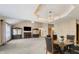 Open dining area with vaulted ceiling, chandelier, and view into the spacious living room at 2557 Cedarcrest Dr, Columbus, IN 47203