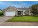 Charming single-story home with well-maintained lawn, brick accents, and attached two-car garage at 2557 Cedarcrest Dr, Columbus, IN 47203