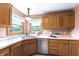 This eat-in kitchen has stainless steel appliances and a bright window overlooking a beautiful yard at 2557 Cedarcrest Dr, Columbus, IN 47203