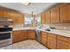 Traditional kitchen features wood cabinets, stainless steel appliances, and a window overlooking the yard at 2557 Cedarcrest Dr, Columbus, IN 47203