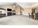 Bright living room with vaulted ceiling, fireplace, display cabinets, and adjacent dining area at 2557 Cedarcrest Dr, Columbus, IN 47203