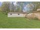 Well-kept backyard featuring a shed, greenhouse, and grassy lawn, perfect for gardening and outdoor storage at 3008 Old State Road 37, Greenwood, IN 46143