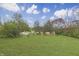 Large, lush backyard with mature trees and green grass, perfect for outdoor activities and relaxation at 3008 Old State Road 37, Greenwood, IN 46143