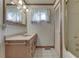 Classic bathroom with wood vanity, patterned walls, and a shower and tub combination at 3008 Old State Road 37, Greenwood, IN 46143