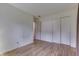 Minimalist bedroom with wood flooring, light walls, and closet space at 3008 Old State Road 37, Greenwood, IN 46143