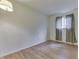 Cozy bedroom with wood flooring, light walls, and large window with striped curtains at 3008 Old State Road 37, Greenwood, IN 46143