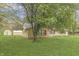 Side view of a single story brick home showing a storage shed in the back yard at 3008 Old State Road 37, Greenwood, IN 46143