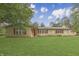 Charming single-story brick home featuring a well-manicured lawn and red window shutters at 3008 Old State Road 37, Greenwood, IN 46143