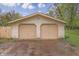 Spacious detached two-car garage with traditional doors and a driveway for convenient parking and storage at 3008 Old State Road 37, Greenwood, IN 46143