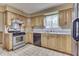 Kitchen with oak cabinets, white countertops, stainless steel appliances, and tiled floors at 3008 Old State Road 37, Greenwood, IN 46143
