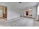 Bright, carpeted living room featuring neutral walls, and entry to the fireplace room at 3008 Old State Road 37, Greenwood, IN 46143