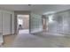 A large open living room featuring outdated decor, two entry ways, white doors and carpeted floors at 3008 Old State Road 37, Greenwood, IN 46143