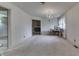 Carpeted living room leads to brick fireplace room, and dining room with chandelier at 3008 Old State Road 37, Greenwood, IN 46143