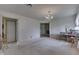 Carpeted living room leads to brick fireplace room, and dining room with chandelier at 3008 Old State Road 37, Greenwood, IN 46143