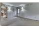 An outdated living room features a white door to the exterior, sconce lighting and outdated wallpaper at 3008 Old State Road 37, Greenwood, IN 46143