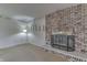 A living room featuring a red brick fireplace, off-white walls, light carpet and a floor lamp at 3008 Old State Road 37, Greenwood, IN 46143