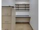 Small storage area featuring built-in shelving, a desk and multiple filing cabinets at 3008 Old State Road 37, Greenwood, IN 46143