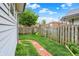 Well maintained backyard with brick pathway and wood fencing at 301 Colescott St, Shelbyville, IN 46176