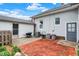 Cozy backyard with brick patio, detached garage, and partial fence at 301 Colescott St, Shelbyville, IN 46176
