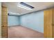 Finished basement featuring blue wallpaper, pink carpet, wooden closets and shelving, and open ceiling at 301 Colescott St, Shelbyville, IN 46176