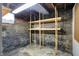 Unfinished basement featuring concrete walls and utilitarian wooden shelving at 301 Colescott St, Shelbyville, IN 46176