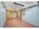 A finished basement area with blue wallpaper and pink carpeting, complete with wood closets and shelving at 301 Colescott St, Shelbyville, IN 46176