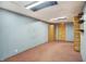 Finished basement featuring blue wallpaper, pink carpet, wooden closets and shelving, and open ceiling at 301 Colescott St, Shelbyville, IN 46176