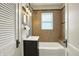 Updated bathroom with tiled walls, a modern vanity, and tub at 301 Colescott St, Shelbyville, IN 46176