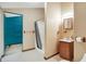 Neutral-toned full bathroom with a shower/tub, vanity, toilet, and view into unfinished room at 301 Colescott St, Shelbyville, IN 46176