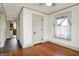 Bedroom showcasing hardwood floors, a window, and a view into the kitchen at 301 Colescott St, Shelbyville, IN 46176