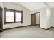 A carpeted bedroom including a window, walk in closet, and high ceiling at 301 Colescott St, Shelbyville, IN 46176
