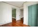 Bedroom with wood floors, vintage wallpaper, and open doorway to another room at 301 Colescott St, Shelbyville, IN 46176
