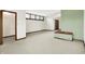 Spacious carpeted bedroom with a walk-in closet, green accent wall, and unique window design at 301 Colescott St, Shelbyville, IN 46176