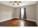 A neutral bedroom with hardwood floors and natural light from a window at 301 Colescott St, Shelbyville, IN 46176