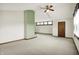 Large bedroom featuring high ceilings, carpet, a fireplace, and a large window at 301 Colescott St, Shelbyville, IN 46176