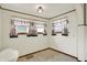 Bright breakfast nook with vintage lighting and natural light from multiple windows at 301 Colescott St, Shelbyville, IN 46176