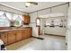 Traditional kitchen with a ceiling fan, warm wood cabinets, and tiled floors at 301 Colescott St, Shelbyville, IN 46176