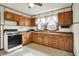 Charming kitchen features ample wood cabinetry and retro appliances at 301 Colescott St, Shelbyville, IN 46176