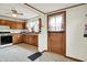 Charming kitchen with vintage appliances, wood cabinets, and tiled floor at 301 Colescott St, Shelbyville, IN 46176