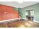 Spacious living room with hardwood floors, stairs, and multiple doorways at 301 Colescott St, Shelbyville, IN 46176