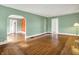 Open floor plan with hardwood floors, arched doorway, and neutral paint at 301 Colescott St, Shelbyville, IN 46176